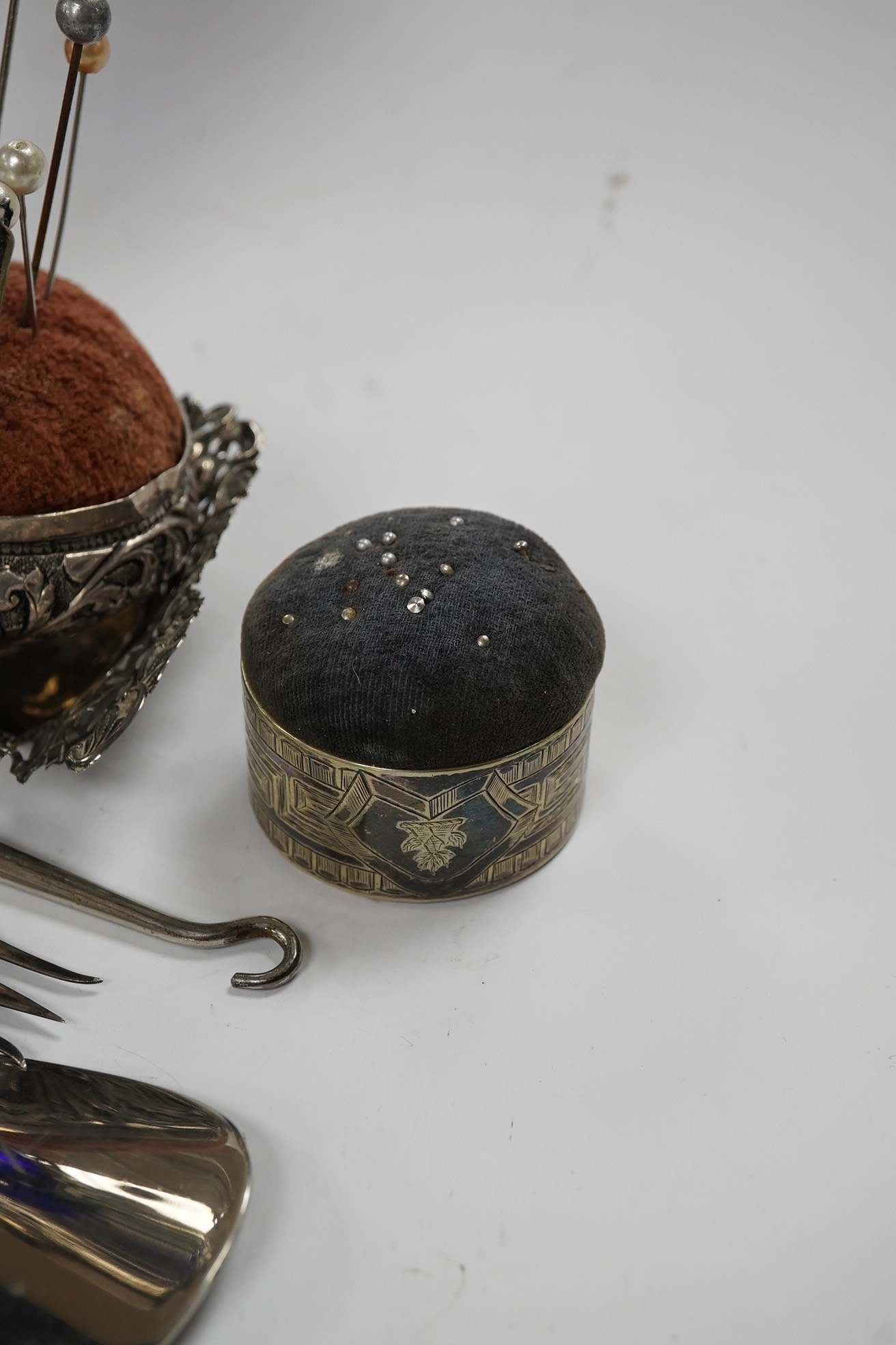 A small group of assorted silver items including mounted blue glass spill vase, 17.2cm, mounted shoe horn and button hook and a trinket dish, together with two other items. Condition - poor to fair
